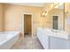 Bright bathroom offers double sink vanity, soaking tub, and private shower at 5595 Rolling Acres Ln, Cumming, GA 30028