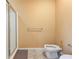 Powder room with ceramic tile features bidet, toilet, and walk-in shower at 5595 Rolling Acres Ln, Cumming, GA 30028