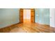Spacious bedroom boasts hardwood flooring and double door entrance at 5595 Rolling Acres Ln, Cumming, GA 30028