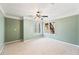 Bedroom featuring a ceiling fan, plush carpeting, and natural light from two windows at 5595 Rolling Acres Ln, Cumming, GA 30028