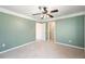 Bedroom featuring a ceiling fan, plush carpeting, and access to walk-in closet at 5595 Rolling Acres Ln, Cumming, GA 30028