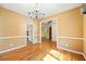 Spacious dining room features hardwood floors and decorative chandelier at 5595 Rolling Acres Ln, Cumming, GA 30028