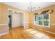 Cozy dining area features large window with natural light and hardwood floors at 5595 Rolling Acres Ln, Cumming, GA 30028