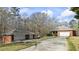 A red brick house and detached two-car garage on a large lot at 5595 Rolling Acres Ln, Cumming, GA 30028