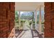Inviting front porch with brick columns offers scenic views of the front yard at 5595 Rolling Acres Ln, Cumming, GA 30028