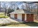 Detached garage features multiple bays, brick construction, and ample parking at 5595 Rolling Acres Ln, Cumming, GA 30028