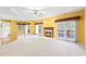 A spacious living room with hardwood floors, fireplace, and a ceiling fan at 5595 Rolling Acres Ln, Cumming, GA 30028