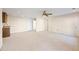 Open living room with a ceiling fan, neutral walls, and a wet bar with granite countertops at 5595 Rolling Acres Ln, Cumming, GA 30028