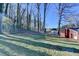 Backyard view features a mix of grassy areas, mature trees, and a chain link fence at 642 Dogwood Dr, Lawrenceville, GA 30046