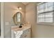 Bright bathroom featuring a vanity with an oval mirror and a window that lets in natural light at 642 Dogwood Dr, Lawrenceville, GA 30046