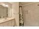 Updated bathroom with a new shower with marble tile, white vanity, and modern fixtures at 642 Dogwood Dr, Lawrenceville, GA 30046