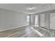 Bright bedroom features light wood floors, neutral paint, and a ceiling access panel at 642 Dogwood Dr, Lawrenceville, GA 30046