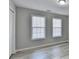 A vacant bedroom with two large windows with blinds and new vinyl flooring at 642 Dogwood Dr, Lawrenceville, GA 30046