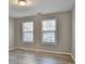 A bright bedroom with two windows, new vinyl floors, and neutral paint at 642 Dogwood Dr, Lawrenceville, GA 30046