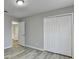 An empty bedroom featuring a closet, new vinyl floors, and natural light at 642 Dogwood Dr, Lawrenceville, GA 30046