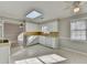 Bright kitchen with white cabinetry, a skylight, and tile flooring at 642 Dogwood Dr, Lawrenceville, GA 30046