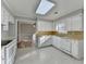 Bright kitchen features white cabinets, tile floors, and natural light at 642 Dogwood Dr, Lawrenceville, GA 30046