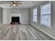 Living room featuring a fireplace, fan, and modern flooring at 642 Dogwood Dr, Lawrenceville, GA 30046