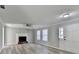 Living room with fireplace, fan, large windows, and stylish flooring at 642 Dogwood Dr, Lawrenceville, GA 30046