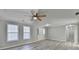 Neutral living room with multiple windows and modern vinyl floors at 642 Dogwood Dr, Lawrenceville, GA 30046