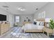 Spacious main bedroom featuring a wooden bed frame, modern gray walls and attractive decor at 642 Dogwood Dr, Lawrenceville, GA 30046