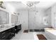 Luxurious bathroom featuring marble floors, double vanity sinks, and a glass-enclosed shower at 2019 Mason Mill Rd, Decatur, GA 30033