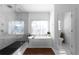 Bright bathroom with free standing tub, marble shower, and natural light from large window at 2019 Mason Mill Rd, Decatur, GA 30033