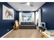 Charming bedroom with hardwood floors, a ceiling fan, and a cozy gray sofa bed at 2019 Mason Mill Rd, Decatur, GA 30033