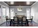 A dining room with an eye-catching modern chandelier and a large table set for six sits on a colorful rug at 2019 Mason Mill Rd, Decatur, GA 30033