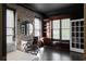 Home office featuring a modern desk, a stylish chaise lounge, built-in shelving and exposed brick walls at 2019 Mason Mill Rd, Decatur, GA 30033