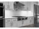 This updated kitchen features stainless steel appliances, white cabinets, and granite countertops at 2019 Mason Mill Rd, Decatur, GA 30033