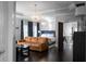 Bright main bedroom with tray ceiling, hardwood floors, large window with curtains, and an adjacent sitting area at 2019 Mason Mill Rd, Decatur, GA 30033