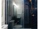 Stylish shower with glass door, navy blue tiles, and a niche for storage at 2019 Mason Mill Rd, Decatur, GA 30033