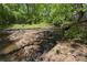 Picturesque creek running through a wooded lot, creating a tranquil natural setting at 2848 Tanner Lake Nw Trl, Marietta, GA 30064