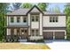Attractive two-story home showcasing a covered front porch, detailed trim, and a spacious driveway leading to a garage at 2848 Tanner Lake Nw Trl, Marietta, GA 30064
