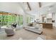 Open floor plan showcasing living room, kitchen, and outdoor deck with wooded view at 2848 Tanner Lake Nw Trl, Marietta, GA 30064