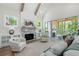 Bright living room featuring a fireplace, beamed ceiling, and access to an outdoor deck at 2848 Tanner Lake Nw Trl, Marietta, GA 30064