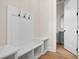 Functional mud room features coat hooks, a bench, and storage shelves at 2848 Tanner Lake Nw Trl, Marietta, GA 30064