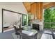 Relaxing screened porch with fireplace, wicker furniture, and wooded view at 2848 Tanner Lake Nw Trl, Marietta, GA 30064