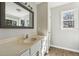 Renovated bathroom with a large mirror, modern fixtures, and a vanity sink at 6165 Short St, Canton, GA 30114