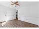 Spacious bedroom with a ceiling fan, wood-look flooring, and a closet perfect for storage at 6165 Short St, Canton, GA 30114