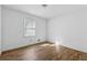 Cozy bedroom featuring a sunny window and sleek wood-look floors at 6165 Short St, Canton, GA 30114