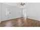Light-filled bedroom with two windows, wood-look floors, and neutral walls at 6165 Short St, Canton, GA 30114