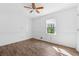 Bright bedroom with a ceiling fan, wood-look flooring, white trim, and a window with natural light at 6165 Short St, Canton, GA 30114