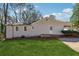 Home exterior features a grassy yard, a deck, and neutral siding with white trim at 6165 Short St, Canton, GA 30114