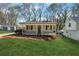 Inviting front view of home with covered porch and well-kept lawn, with a small building visible on the left at 6165 Short St, Canton, GA 30114