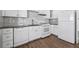 Modern kitchen featuring white cabinets, a subway tile backsplash, granite countertops, and stainless steel appliances at 6165 Short St, Canton, GA 30114