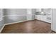 Well-lit kitchen featuring white cabinetry, stainless steel appliances, and wood-look flooring at 6165 Short St, Canton, GA 30114