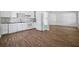 Bright kitchen and living area featuring white cabinets, wood-look flooring, and modern appliances at 6165 Short St, Canton, GA 30114