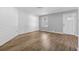 Bright living room boasts beautiful wood-look flooring, a large window, and a stylish accent wall at 6165 Short St, Canton, GA 30114